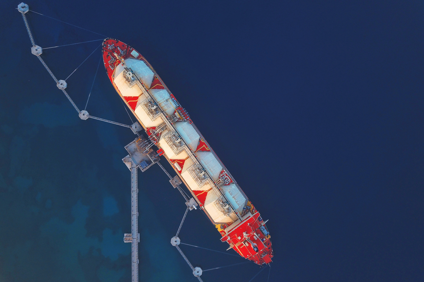 High angle view of an LNG Tanker moored to the jetty to supply Liquified Natural Gas to the Power Station.