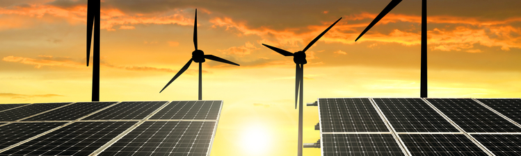 solar energy panels and wind turbines at sunset